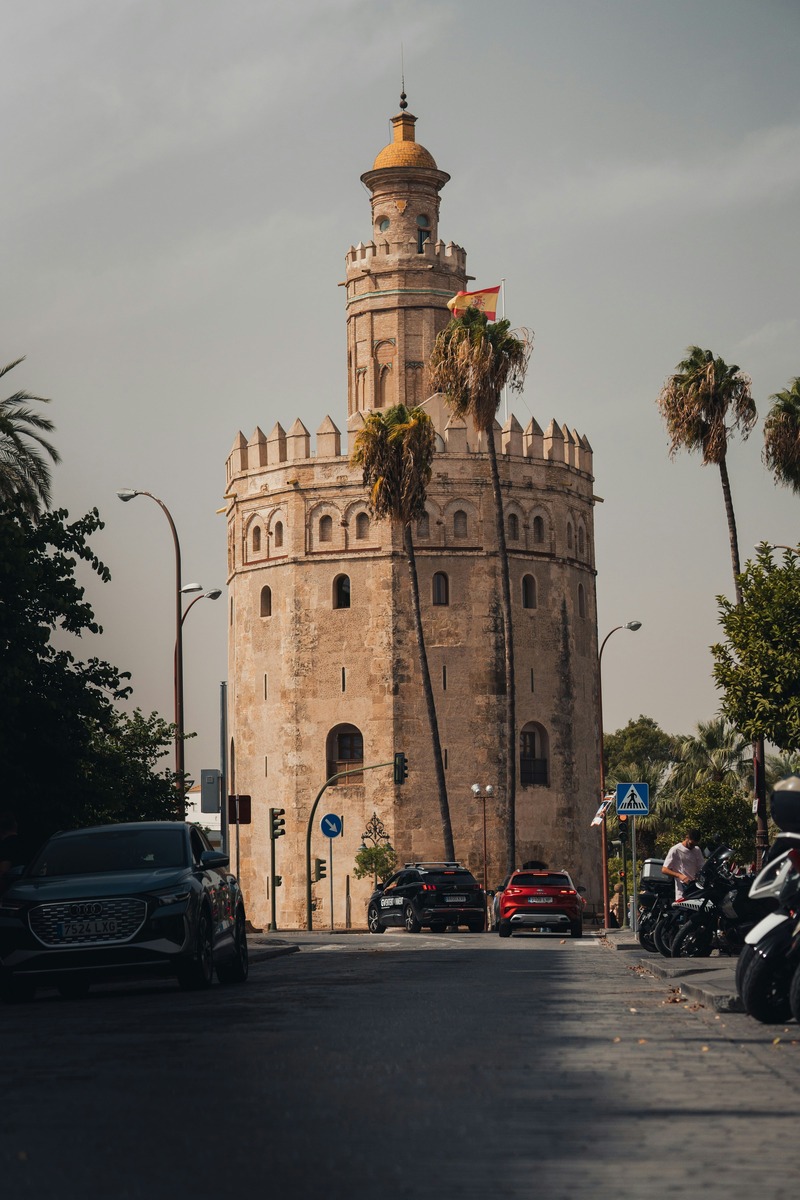 La Torre del Oro al final de la calle, con el tráfico del paseo en primer plano